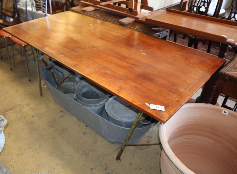A vintage stained oak and wrought iron trestle table, W.177cm, D.86cm, H.72cm